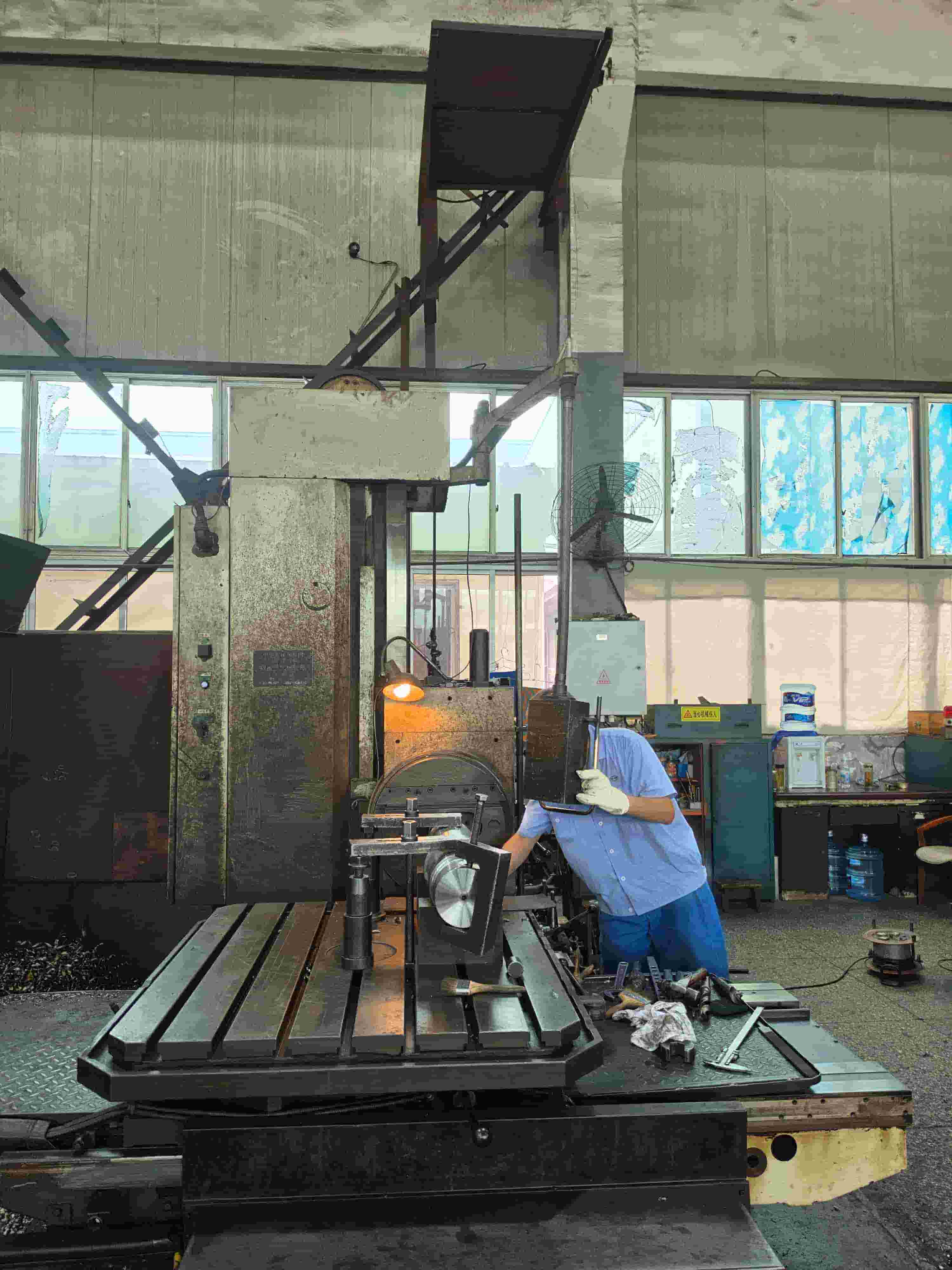 Components of the lead extruder are under careful machining.