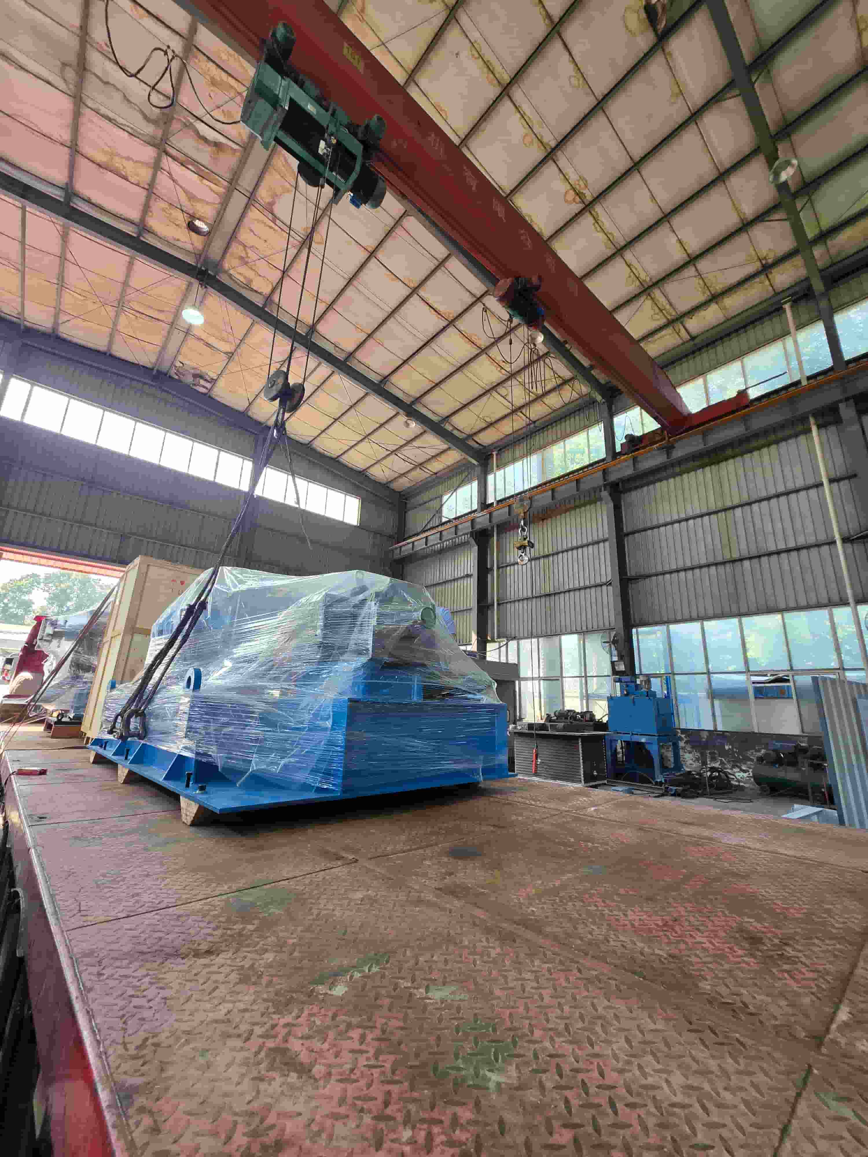 The continuous lead extruder for overseas shipment is being loaded.